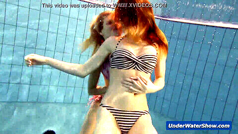 Horny girls strip each other underwater in the pool