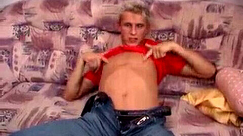 Sultry blonde twink gets a hot load on his stomach after intense solo session on the couch