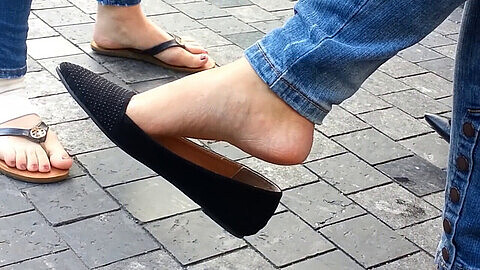 Candid close-up of Chinese beauty seductively dangling her flat shoes - perfect for foot fetish enthusiasts!