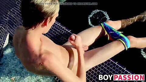 Blonde twink Tyler Thayer strokes his big cock by the pool