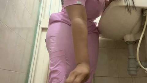 Naughty nurse caught peeing in public bathroom on camera