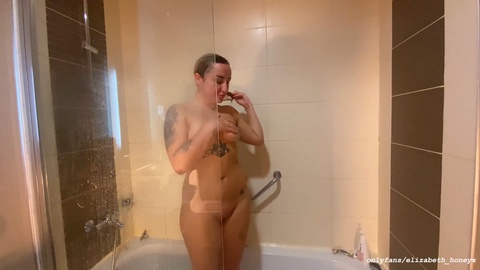 Tattooed nympho enjoys a solo session in the shower, but her horny neighbor catches her and gives her a wild fuck