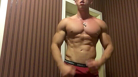 Intensely shredded college dude flexes his muscular abs