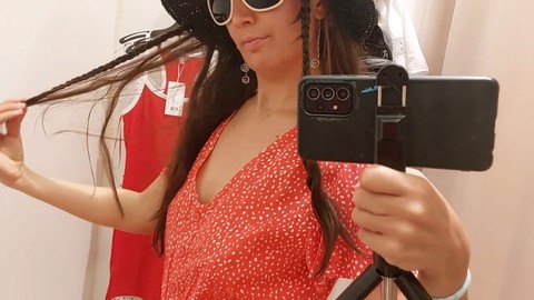 Amateur brunette shows off her thick tits and furry pussy while trying on clothes in the fitting room