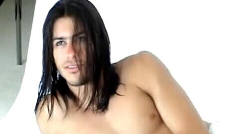 Muscular surfer with long hair flexes, poses for a photoshoot, jerks off, and takes a shower