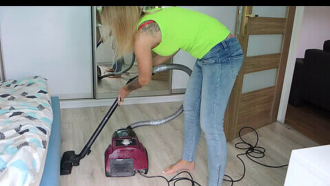 Maid cleaning the apartment with a vacuum cleaner