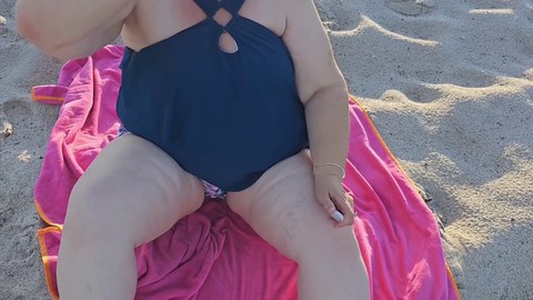 Milf with a juicy booty having fun at the beach