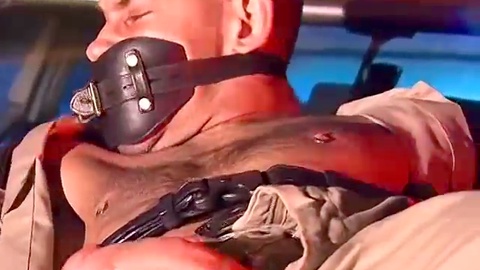 Derek, the corrupt cop struggles to untie himself from his bondage