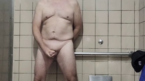 Senior man gets naked and jerks off in a spacious men's room stall