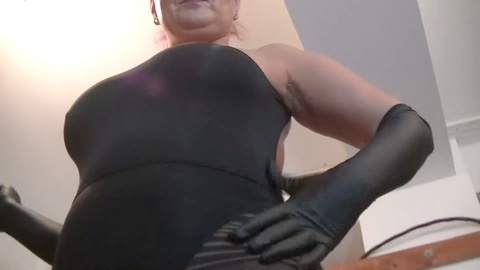 Domme Andreea teases her slave in a revealing catsuit in the bathroom